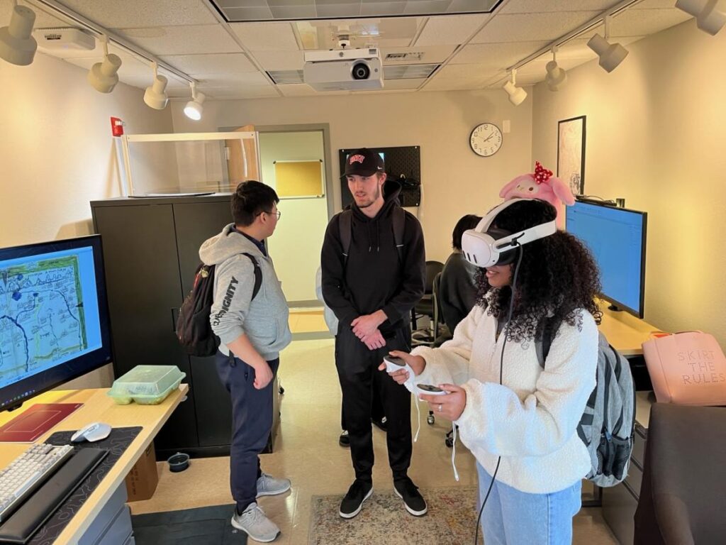 three students trying the VR headset